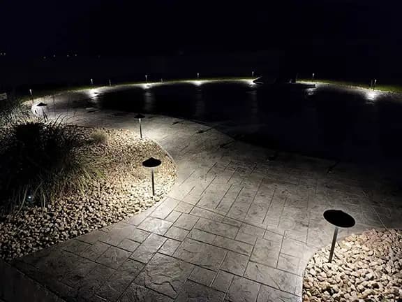 Large patio and pool area with professional ground and perimeter uplighting