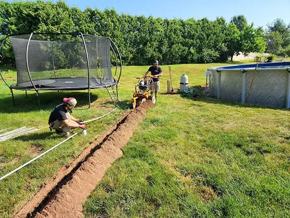 Above-ground pool installation with crew trenching for electrical conduit