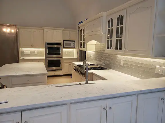 Modern kitchen renovation with professional recessed and under-cabinet lighting